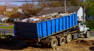 Roll-Off Waste Truck emptying construction debris from industrial site